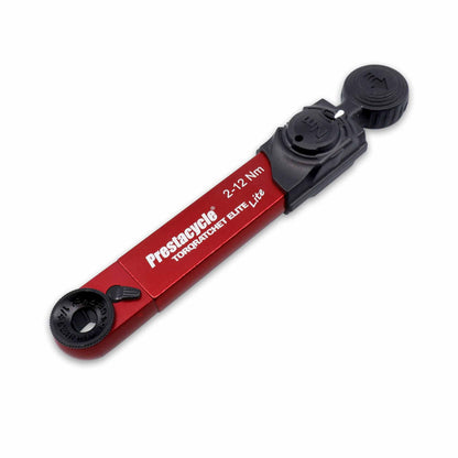 The Prestacycle TorqRatchet ELITE Lite is a portable 2–12 Nm torque multi-tool ratchet in red and black, featuring adjustment dials, clear measurement markings, and a reversible ratchet for versatile bike use.